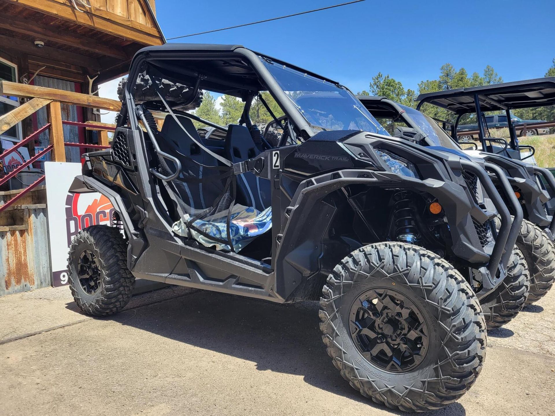 A row of atvs are parked in front of a building.