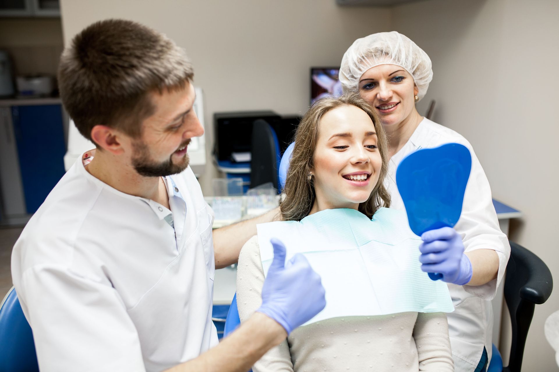 Patient smiling after a cosmetic dental treatment with bright, natural-looking teeth in a modern den
