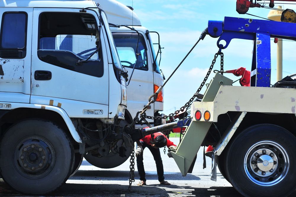 Tow Truck Hooking a White Semi-truck Cab on a Road — Reliable Towing Services in Coffs Harbour, NSW