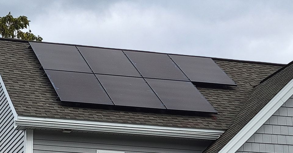 A row of solar panels on the roof of a house