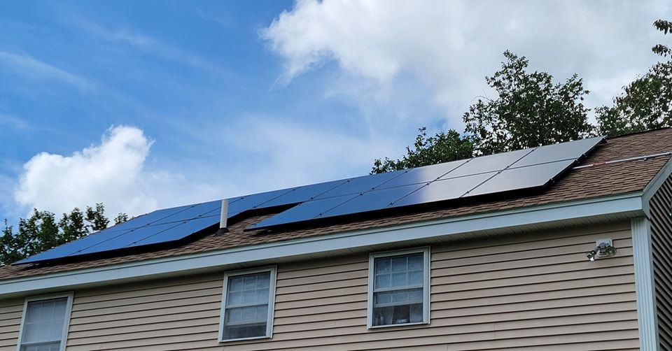 A house with a lot of solar panels on the roof