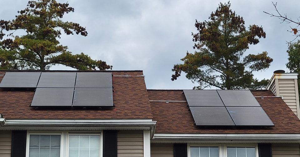 Two solar panels on the roof of a house