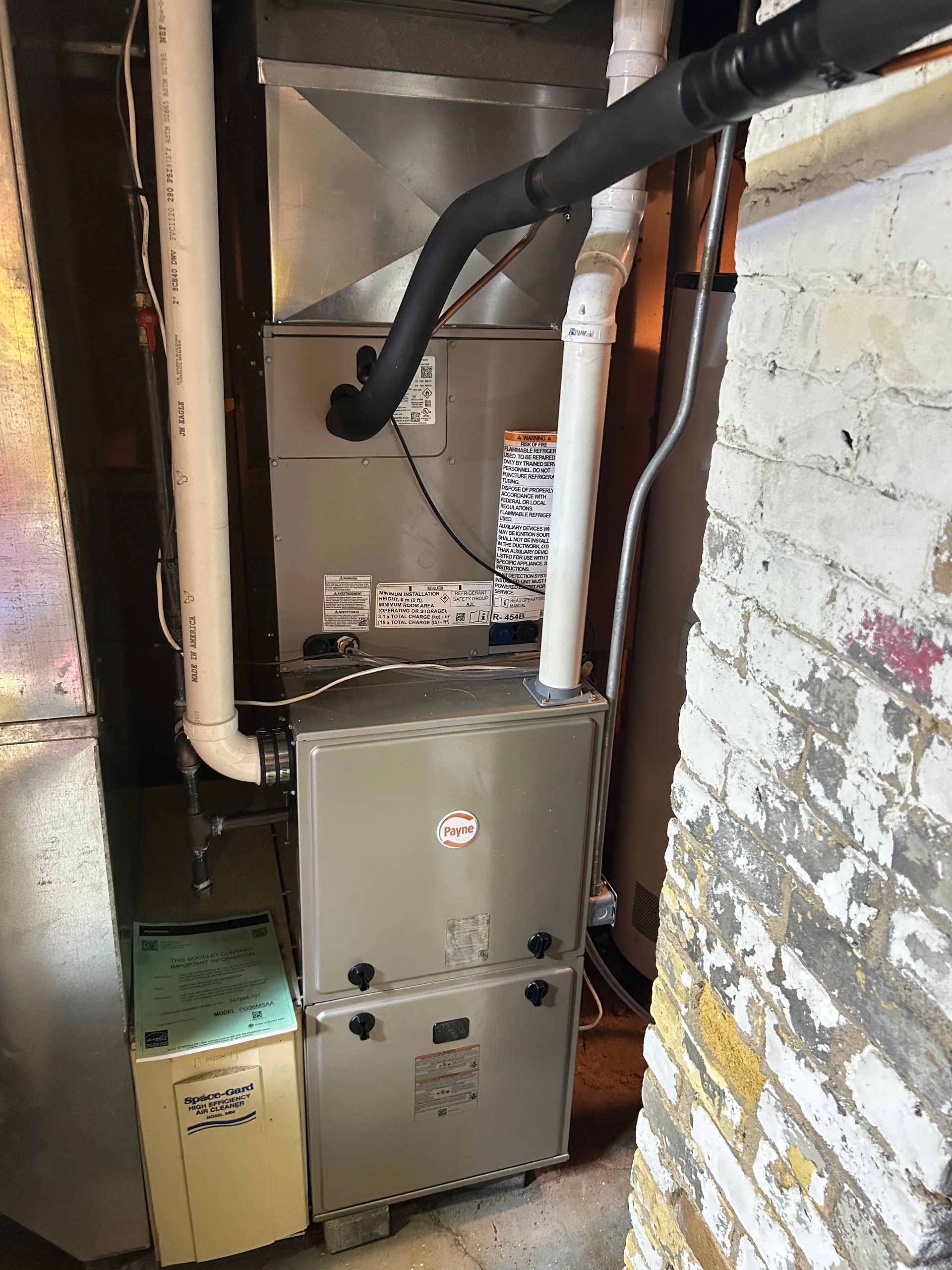 Furnace unit in a basement, with ductwork and a humidifier.