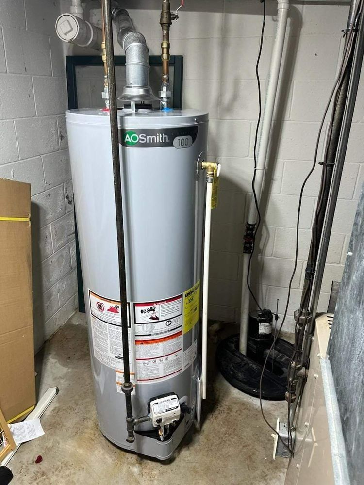 A gray AO Smith water heater in a basement. Pipes and a pump are also visible.