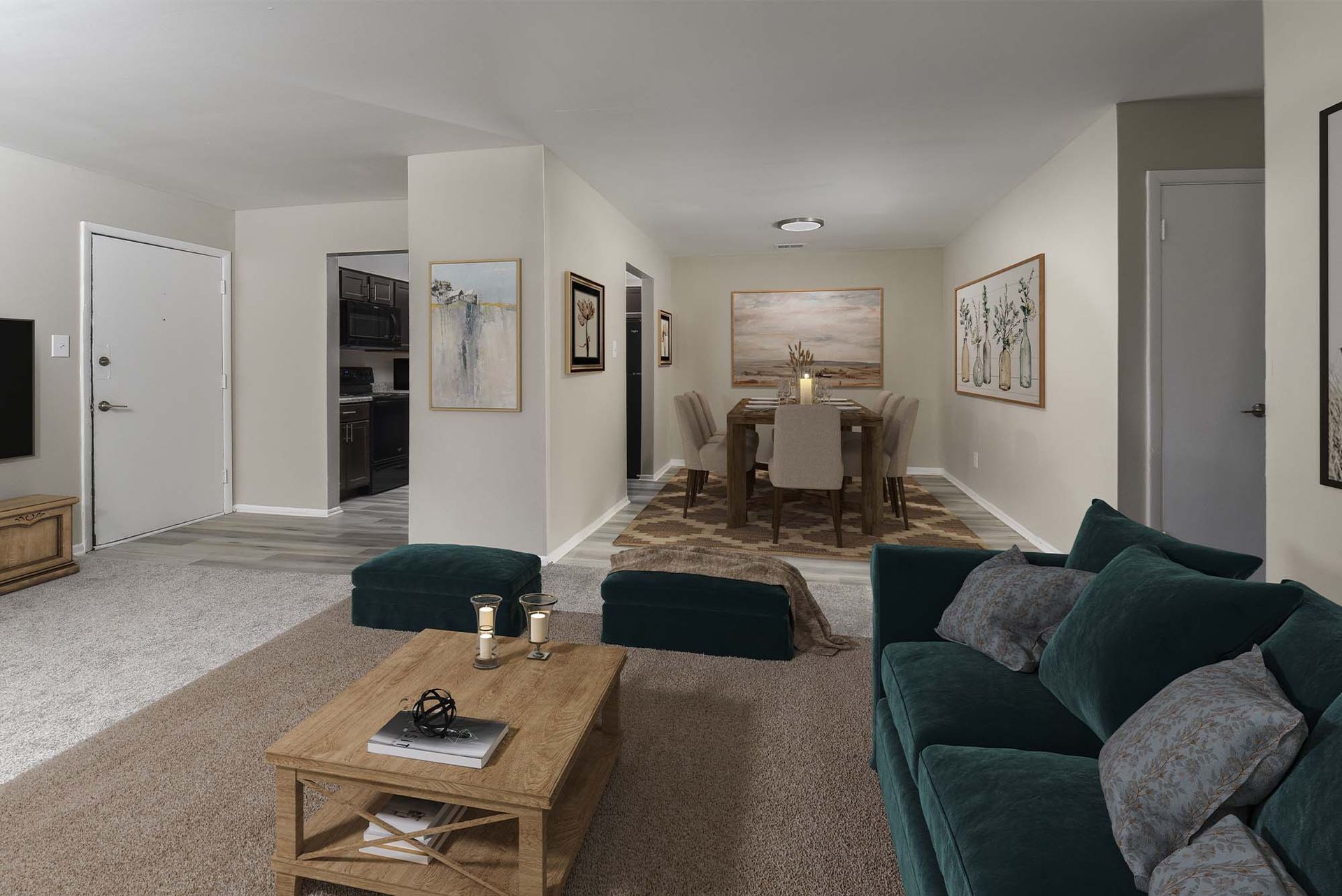 Open-concept living area with a teal sofa, wooden coffee table, and a dining area in the background.