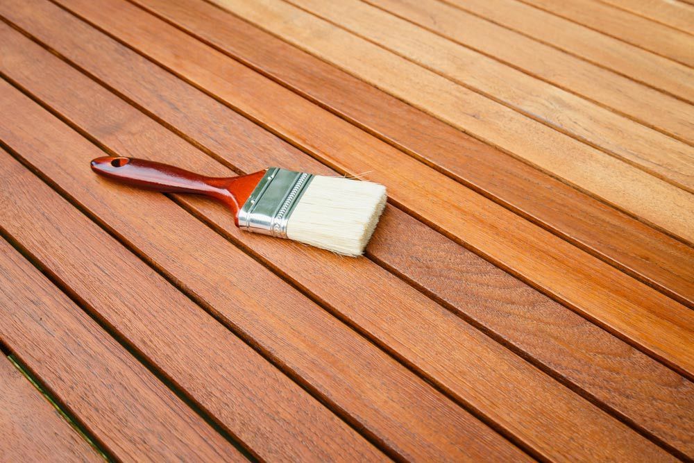 A Brush is Sitting on Top of a Wooden Table — Coastline Floor Sanding in Gosford, NSW