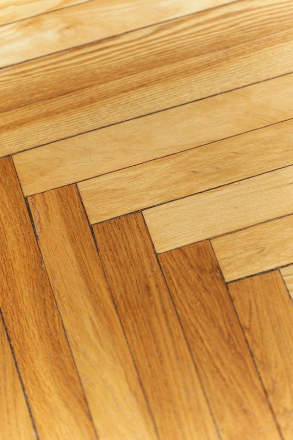 A Close Up of a Wooden Floor With a Herringbone Pattern — Coastline Floor Sanding in Erina, NSW