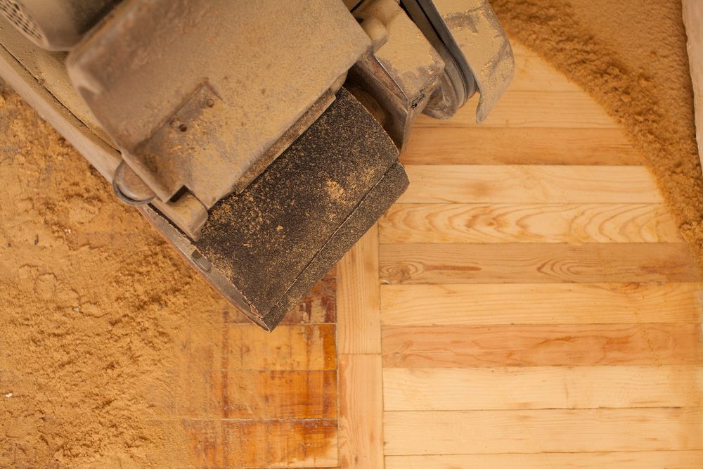 A Sander is Being Used to Sand a Wooden Floor — Coastline Floor Sanding in Gosford, NSW