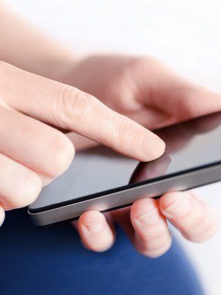 Mans hand holding a mobile phone