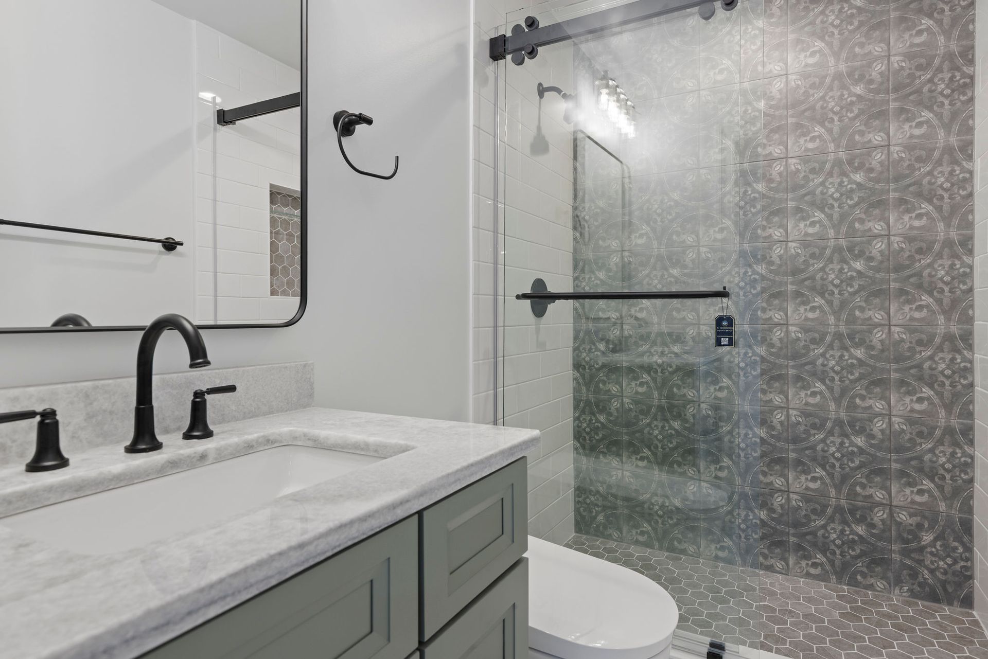 A beautifully finished bathroom with new tile, and updated design, part of a whole-home renovation.