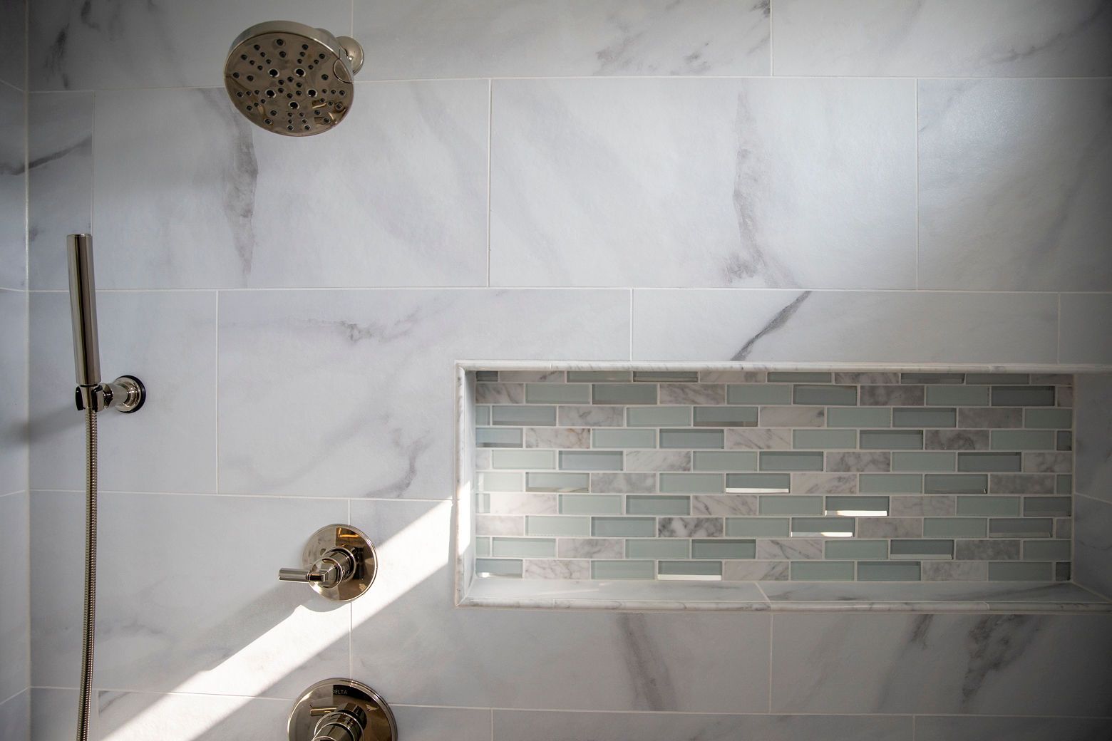 A beautifully remodeled master bathroom with new tile, high-end finishes, and a contemporary design.