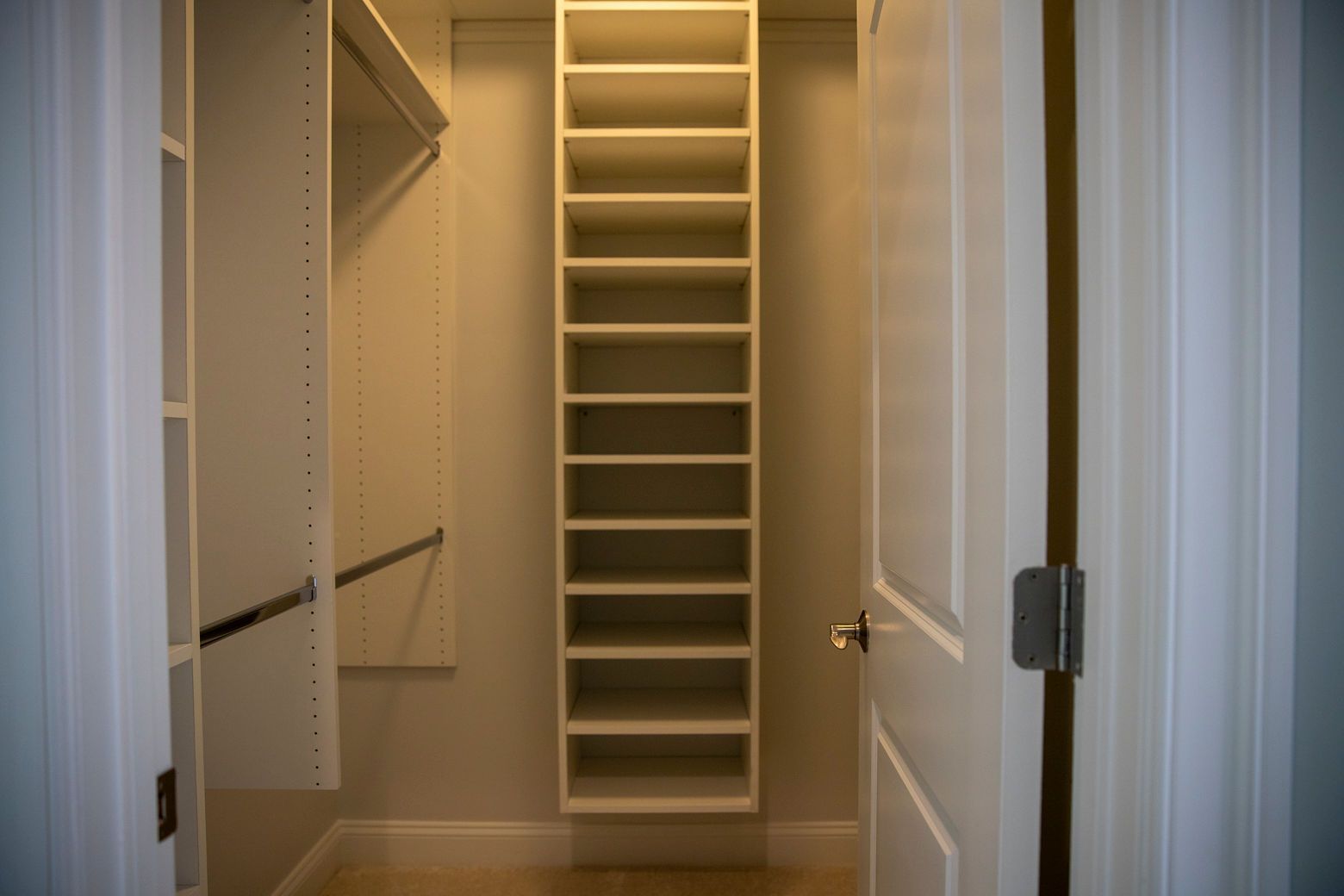 A custom-built walk-in closet with new shelving and organized storage, part of a bedroom remodel.
