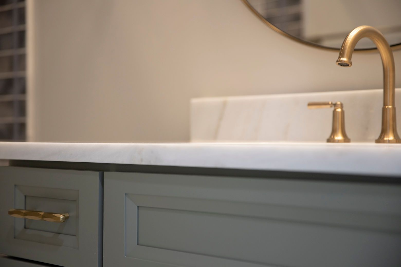 Custom bathroom vanity with a marble countertop and a stylish mirror.