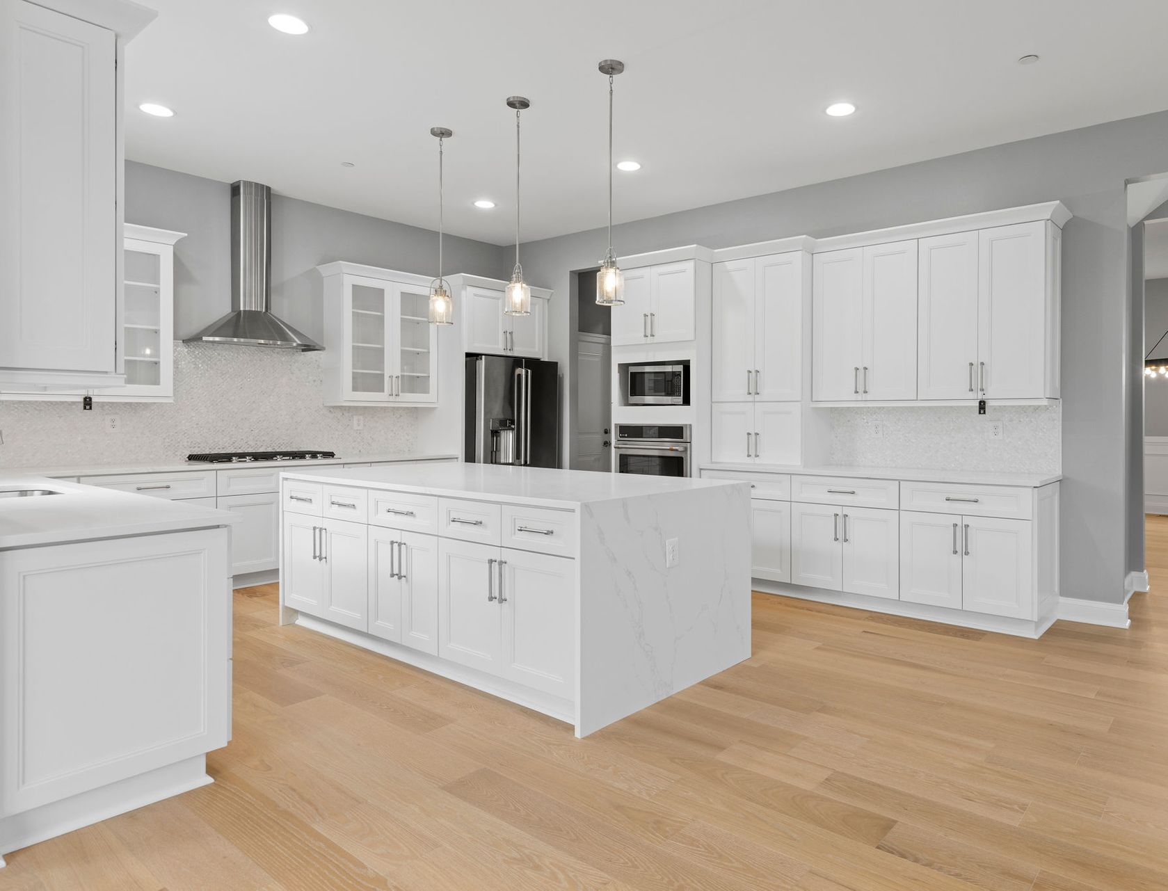 A complete kitchen transformation with new cabinets, a large island, and sleek finishes.