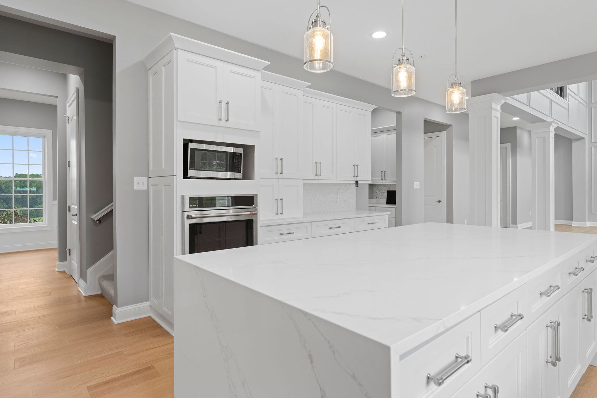 Full kitchen remodel in Maryland. This modern design features white cabinets and a spacious kitchen island.