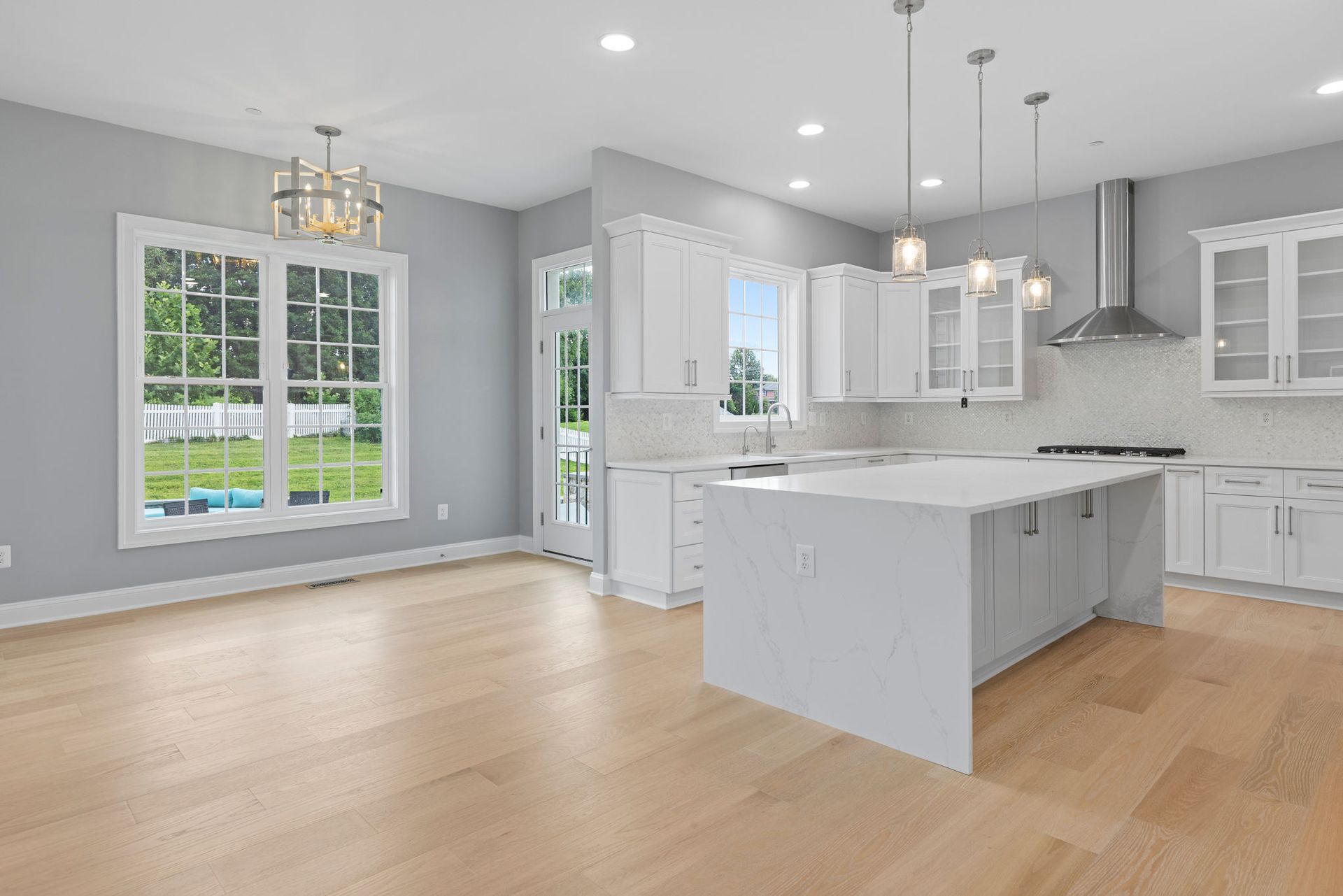 Beautifully remodeled kitchen with sleek, new stainless steel appliances and a subway tile backsplash.