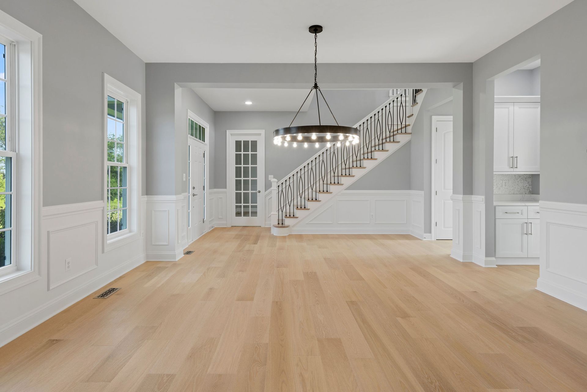 We transformed this dining space by installing new hardwood floors and detailed wall paneling.