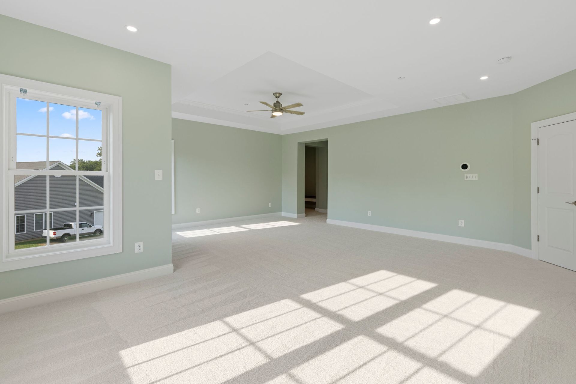 A bright, modern master bedroom after a full-scale remodel, designed with clean lines and a simple, elegant style.