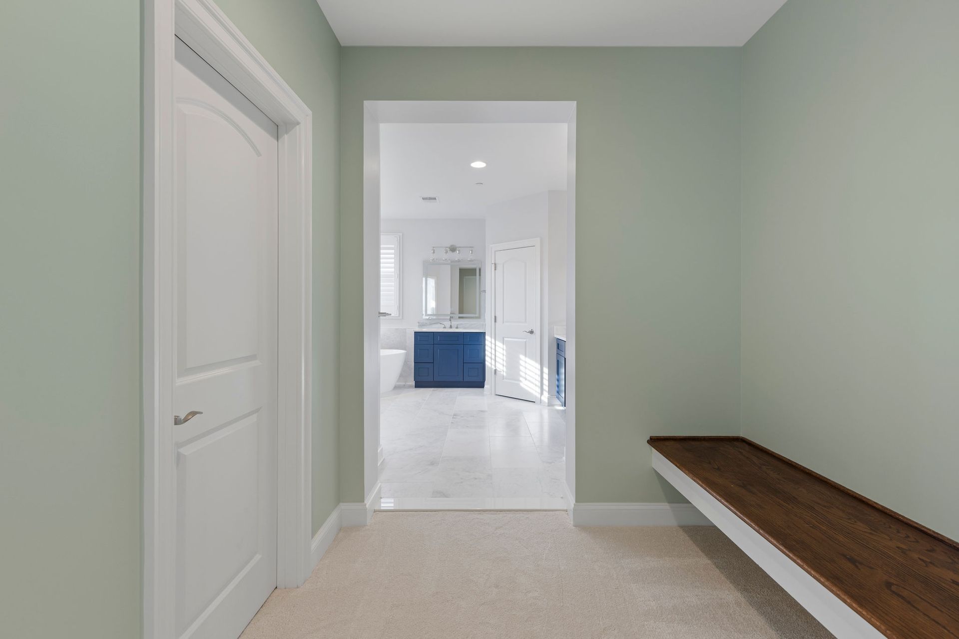 : A custom-built wooden bench with storage underneath, part of a new mudroom.