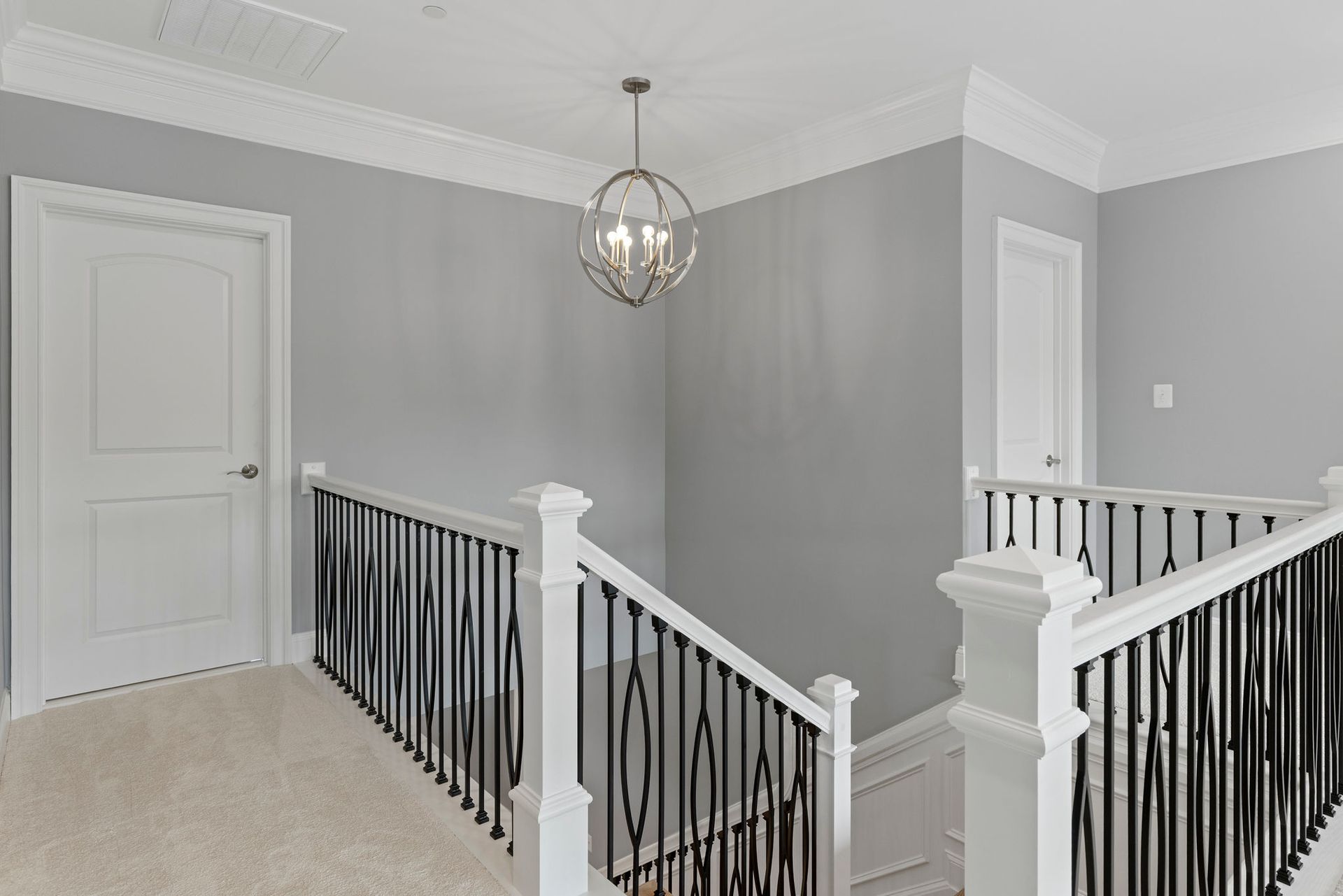 A beautifully finished hallway with a new stair railing, adding a modern touch to the home's second story.