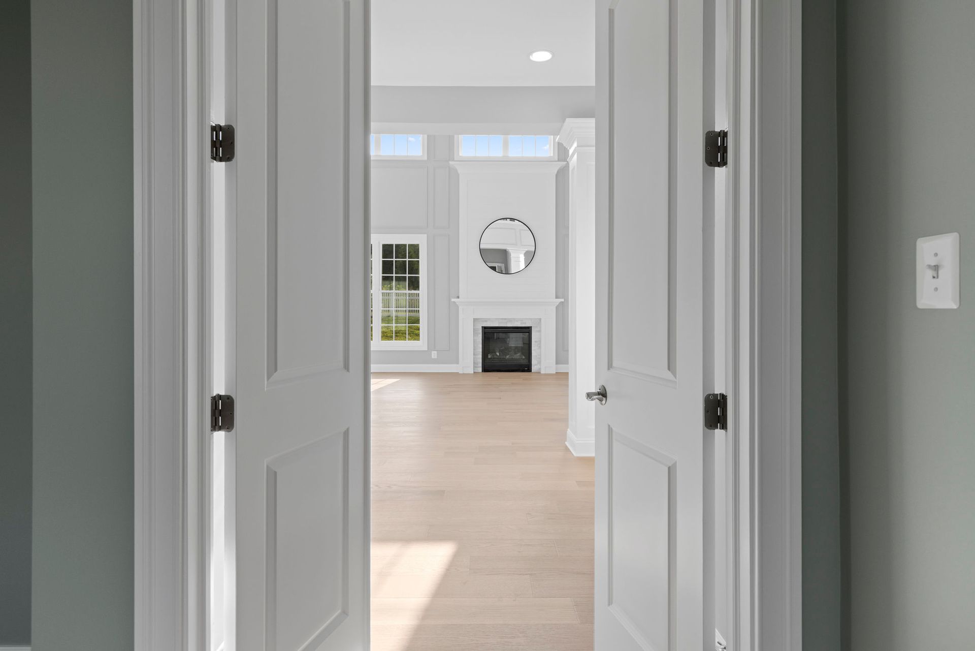 A completely redesigned living room showcasing a full fireplace remodel and new, custom wainscoting.