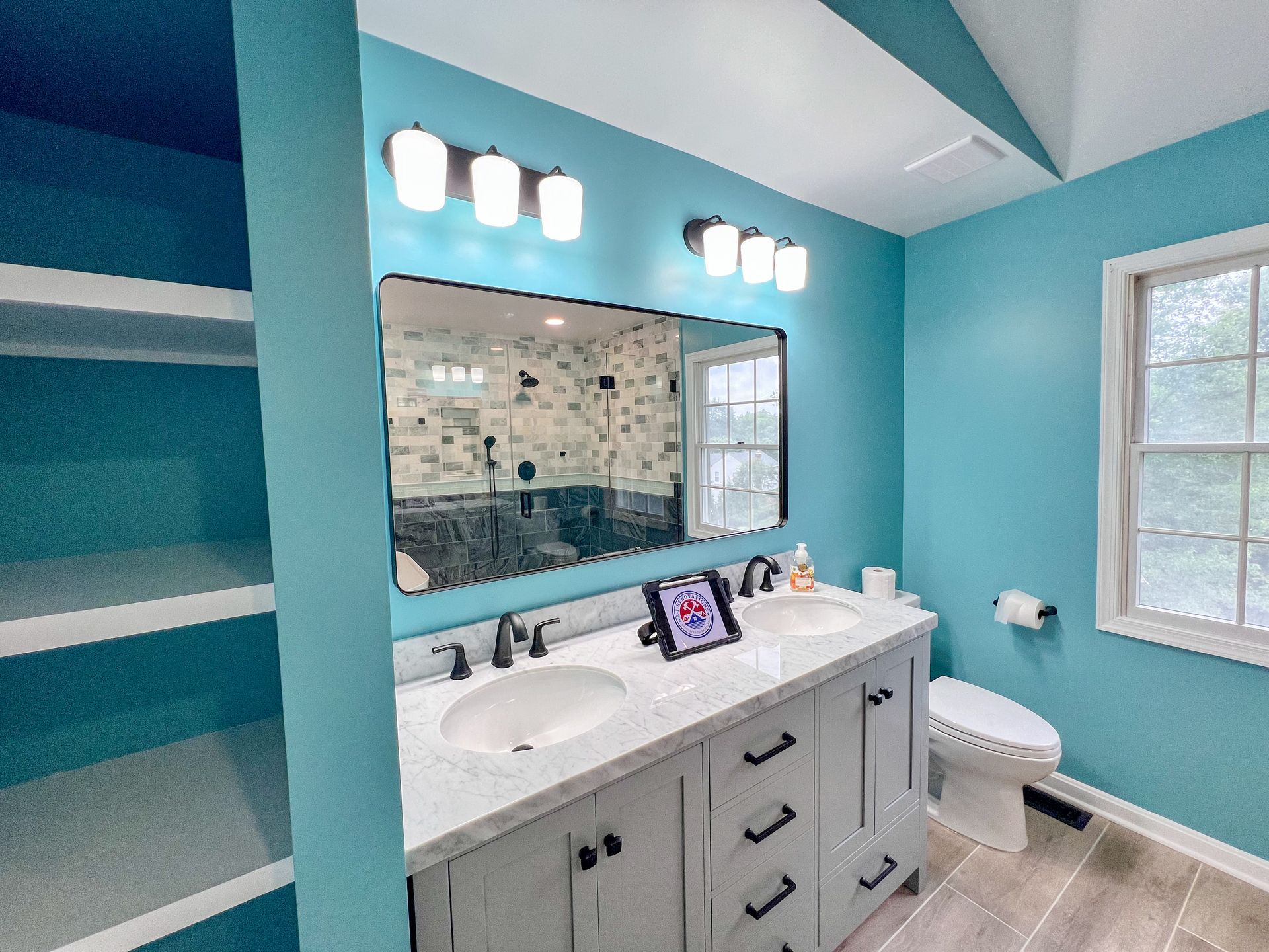 Completed bathroom remodel in Ellicott City, MD, showcasing a spacious walk-in shower, freestanding tub, and contemporary design.