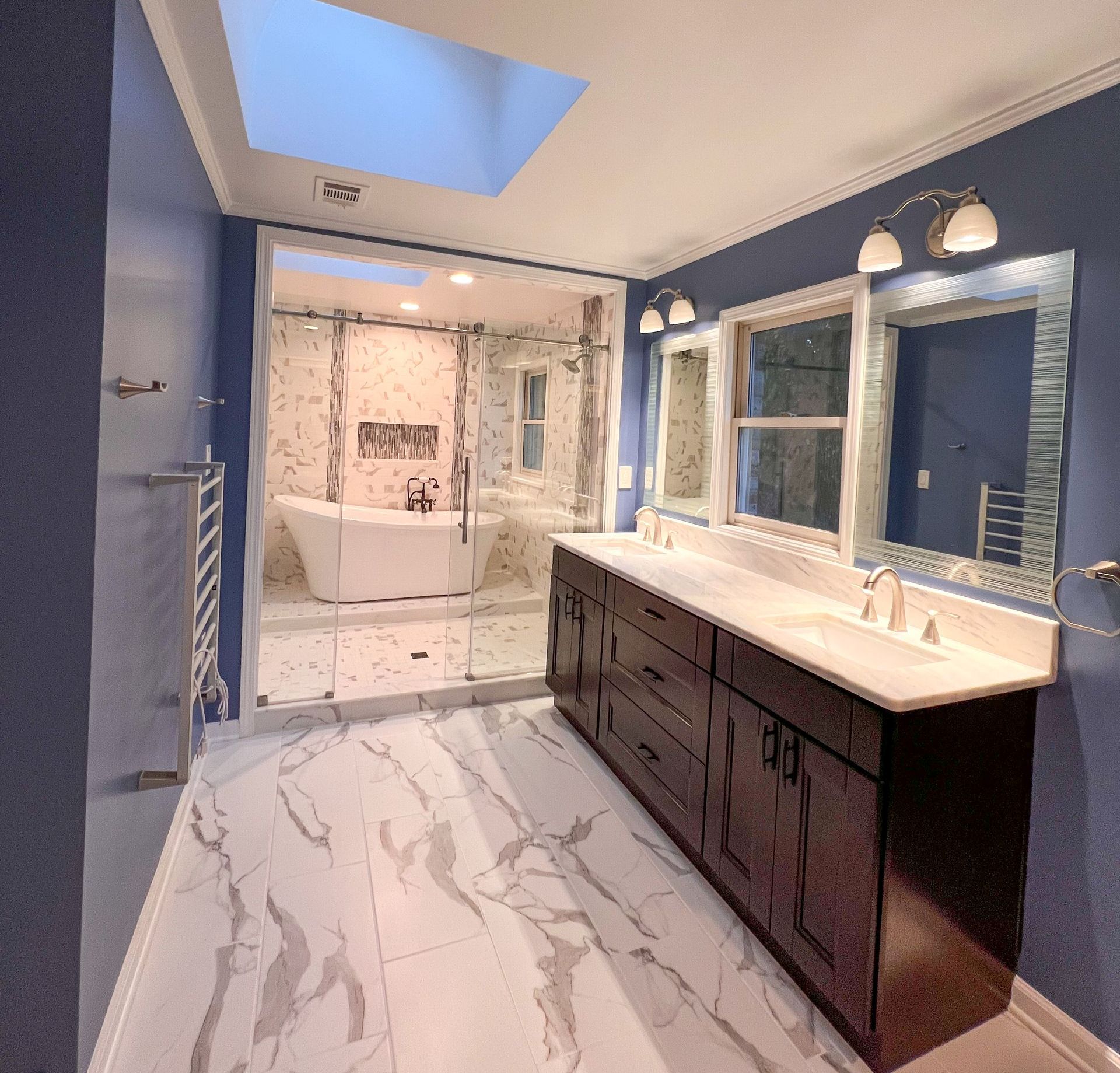 Luxurious bathroom remodel featuring a freestanding soaking tub, walk-in shower, and double vanity.