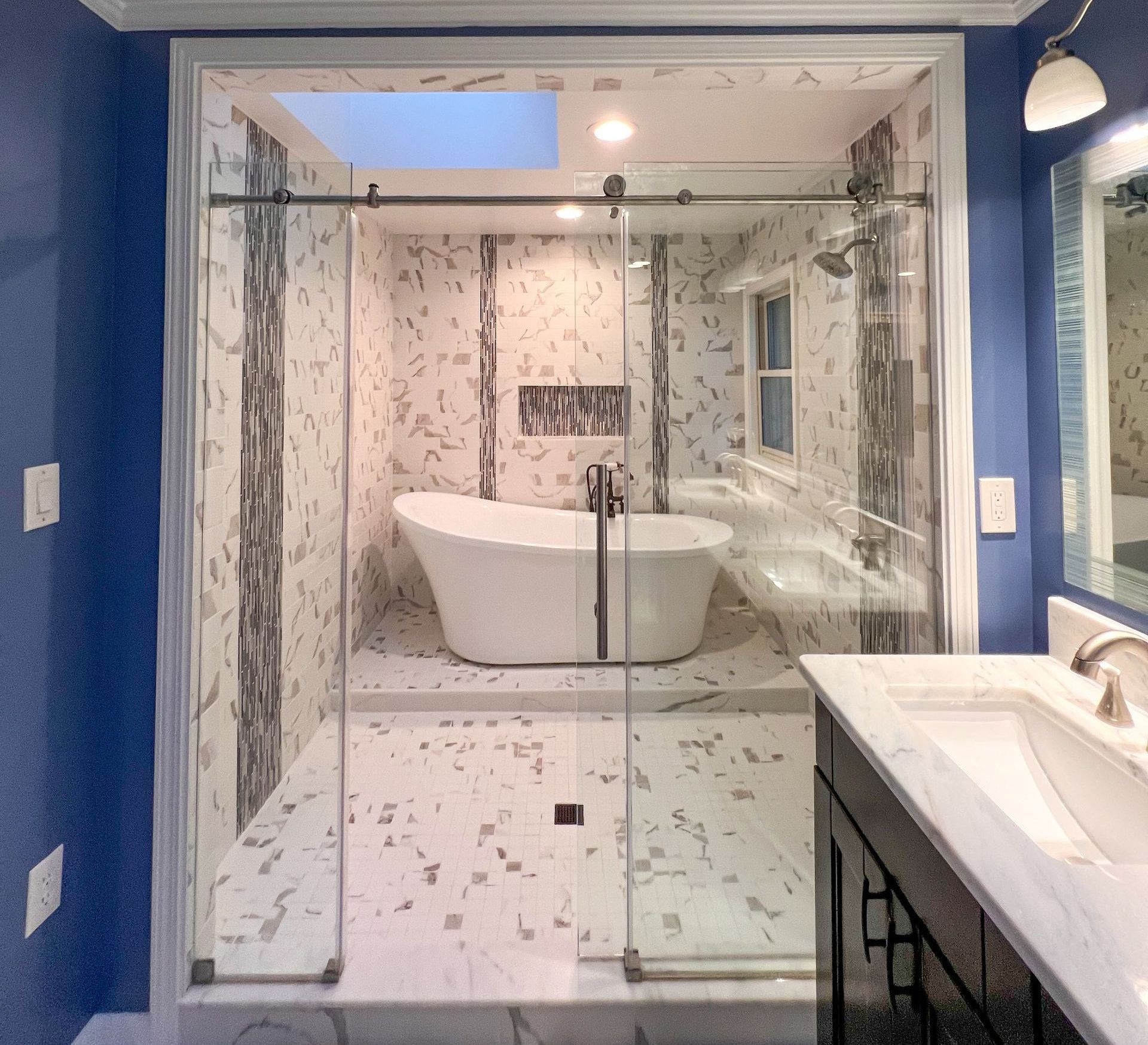 Modern bathroom with freestanding tub and shower.