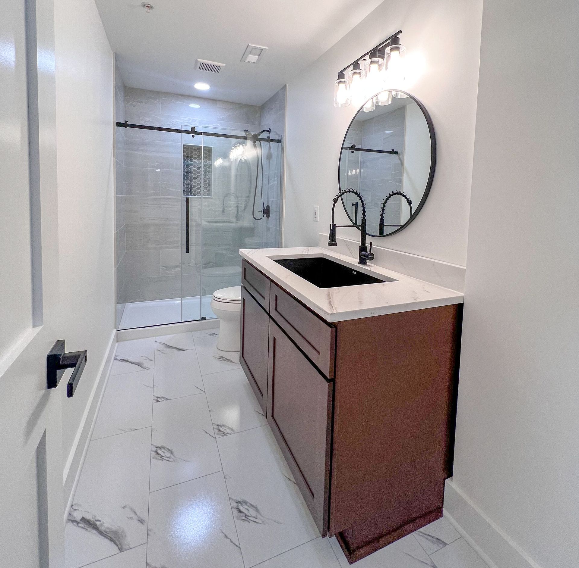 Contemporary basement bathroom in Owings Mills with a sleek vanity and modern shower.