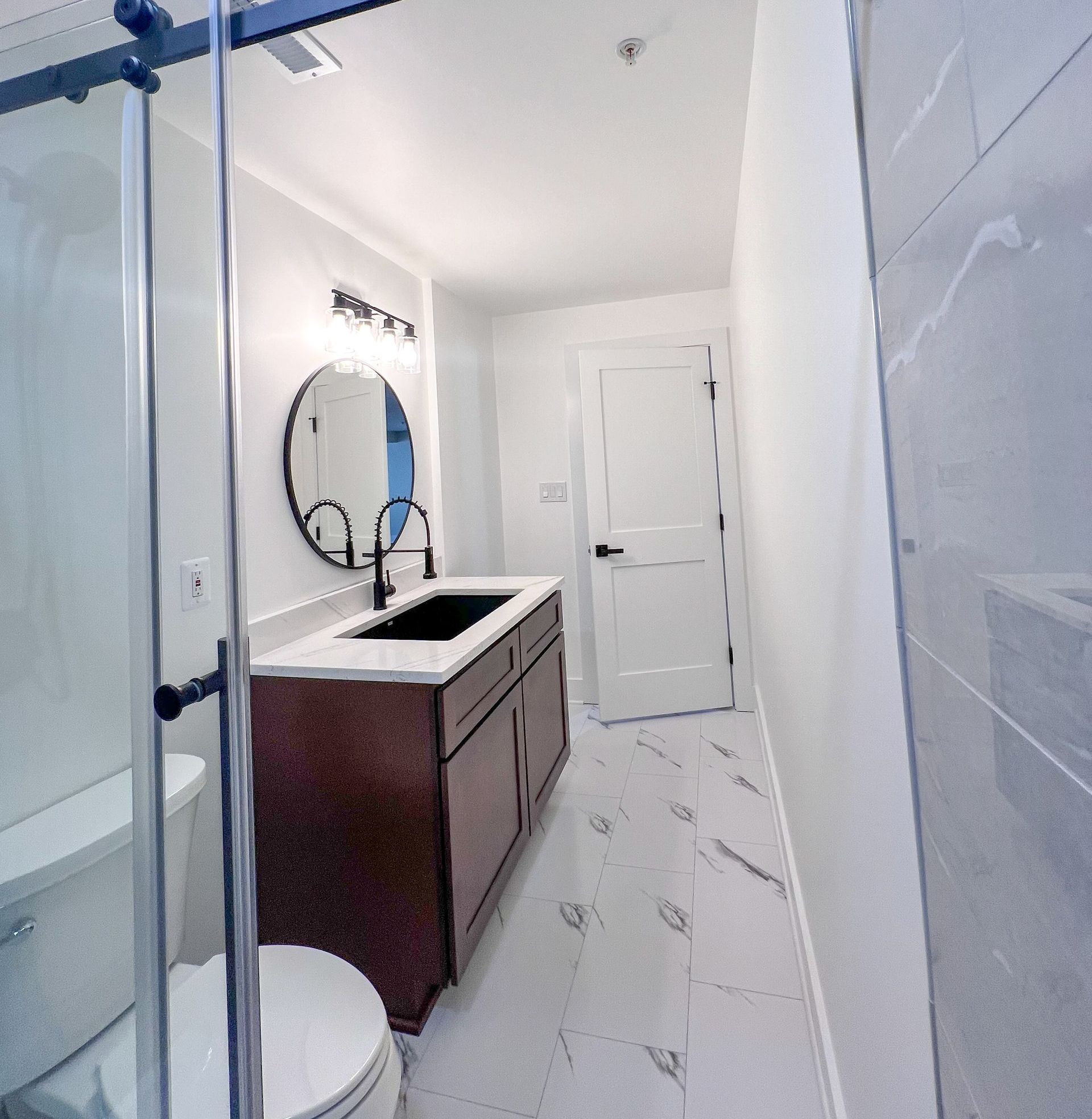 Owings Mills bathroom featuring a spacious walk-in shower and single vanity.