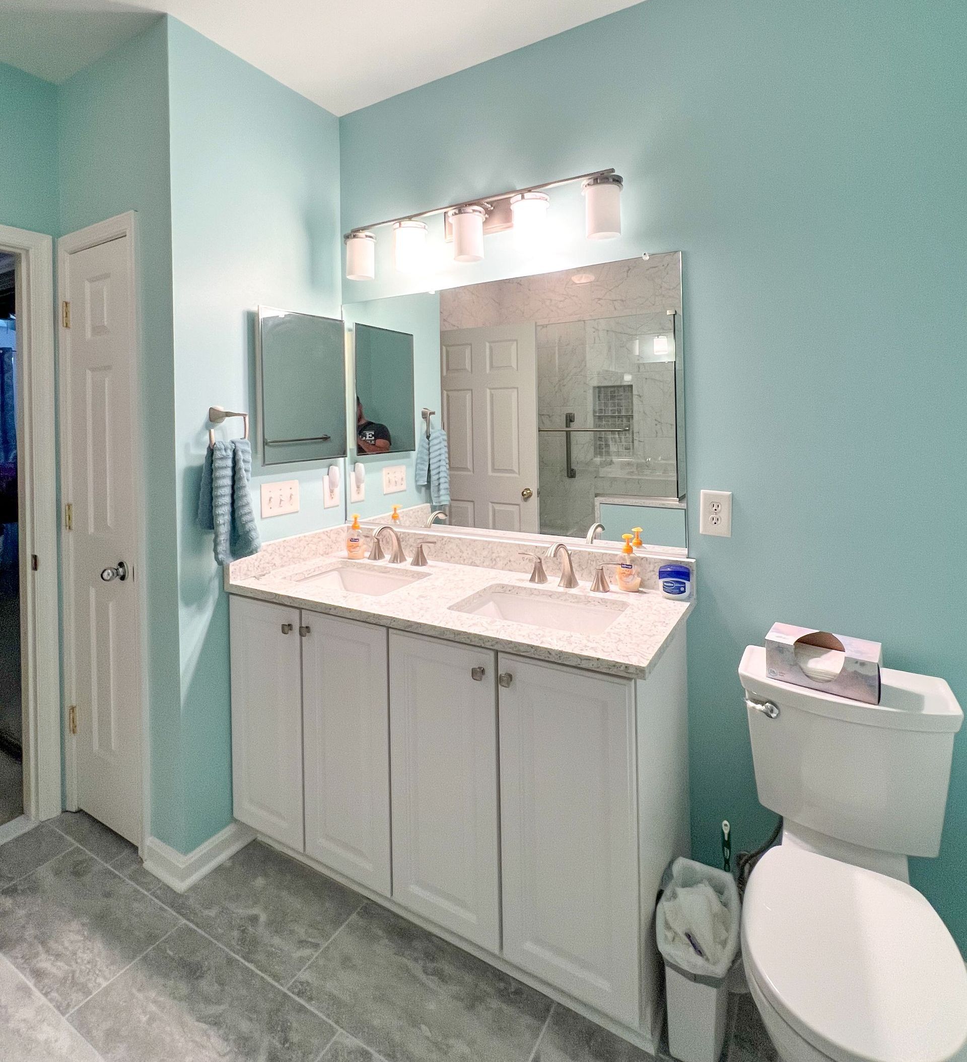  Modern white vanity with dual sinks in a renovated bathroom.