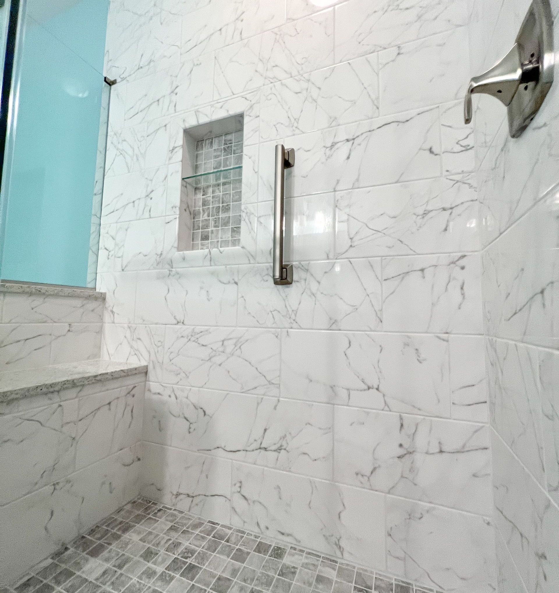 Shower controls and grab bar detail.