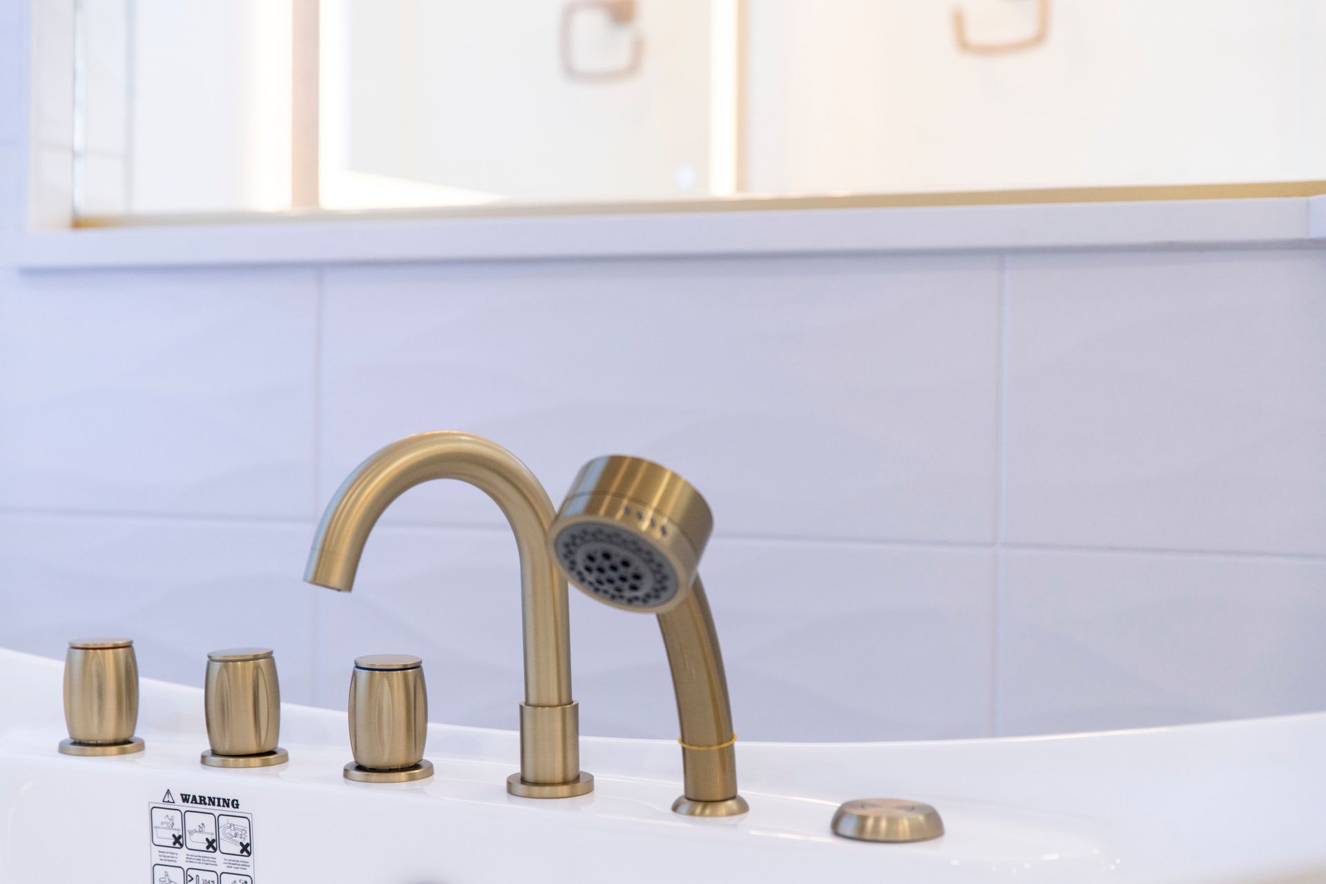 A detail shot of the new gold tub filler and faucet, showcasing the high-quality fixtures.