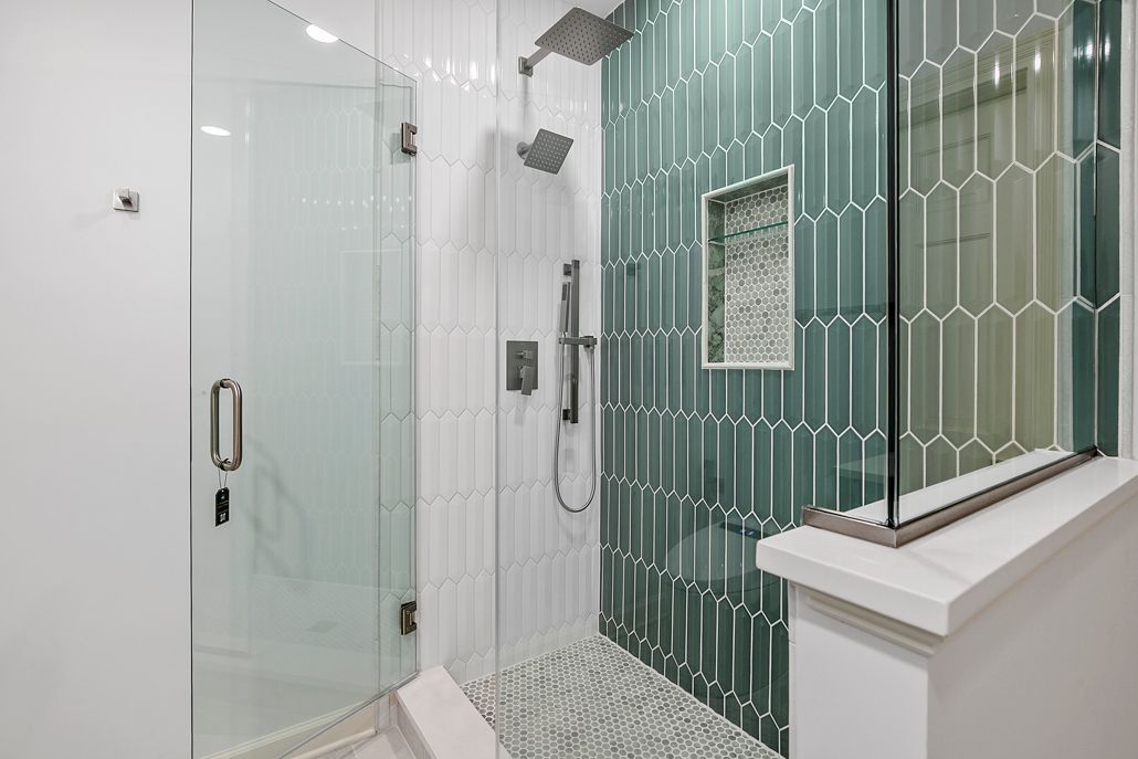 Spacious walk-in shower with dual shower heads and a bold tiled accent wall, part of a recent bathroom renovation.