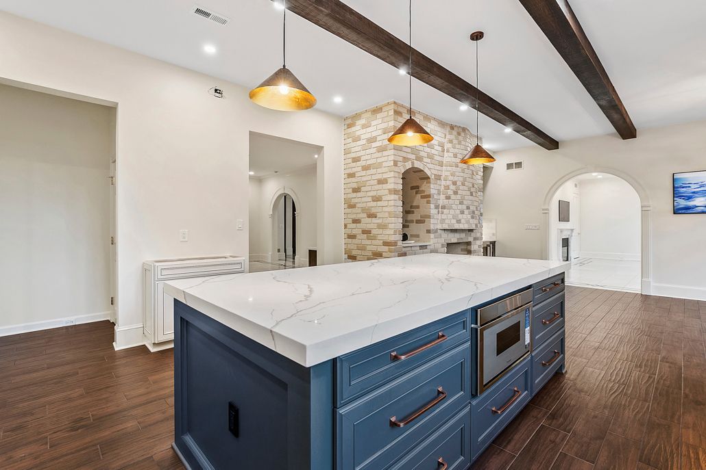 An elegant view of the living area with a newly updated fireplace and unified wood-look tile flooring.