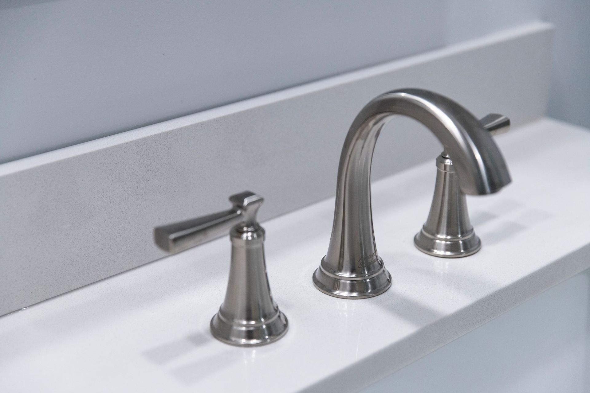 Detailed shot of an elegant brushed nickel faucet, highlighting the high-quality finishes used in this remodel.