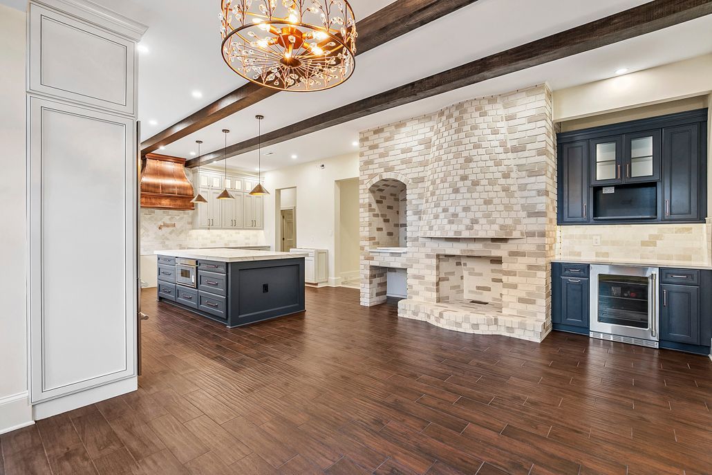 A renovated kitchen space featuring a large bank of windows that fill the room with natural light.