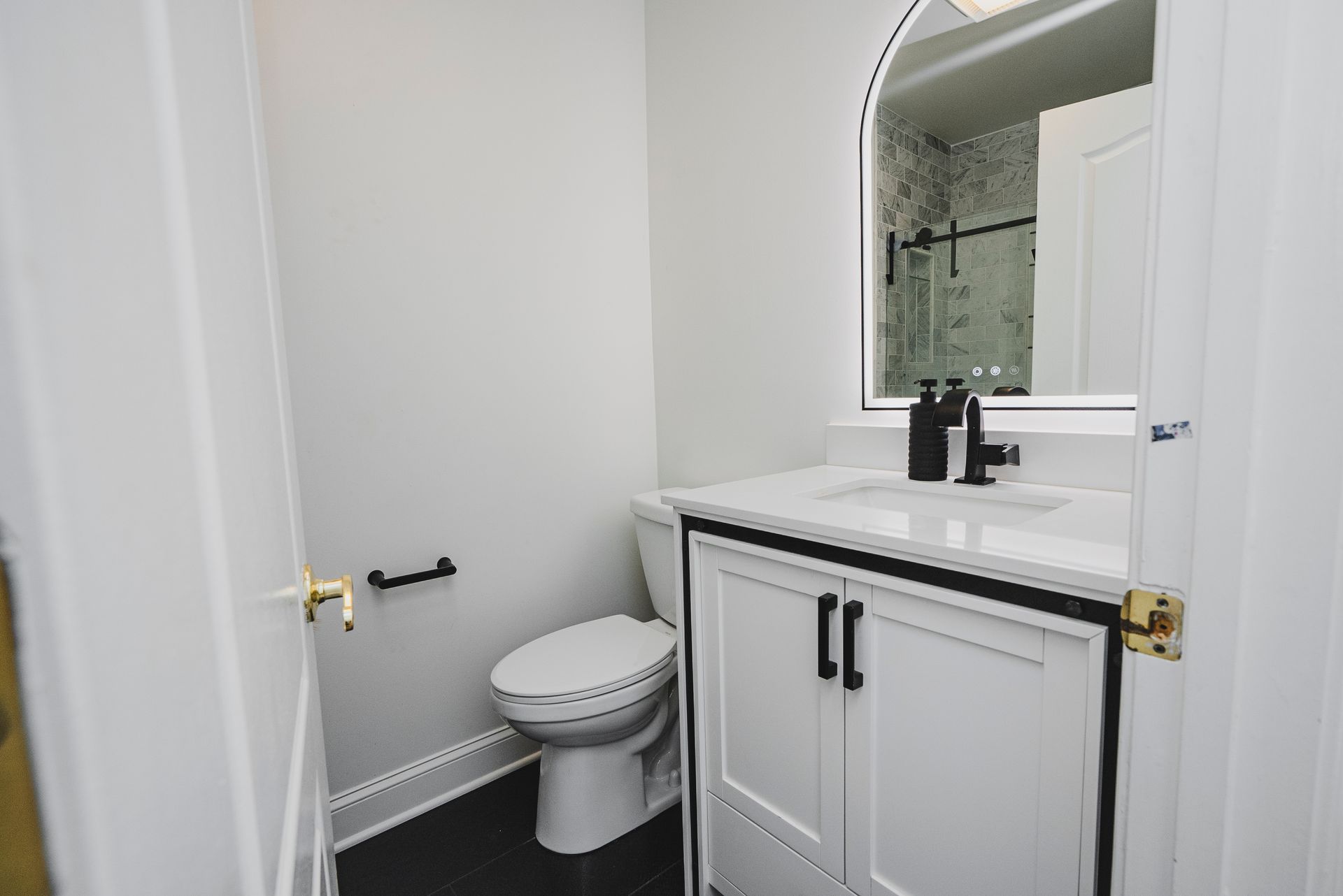 Modern bathroom vanity with clean white finishes and premium dark metal pulls.