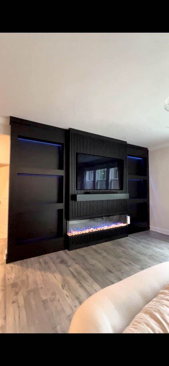 Custom floating shelves with integrated LED accent lighting and hidden brackets in a luxury living room.
