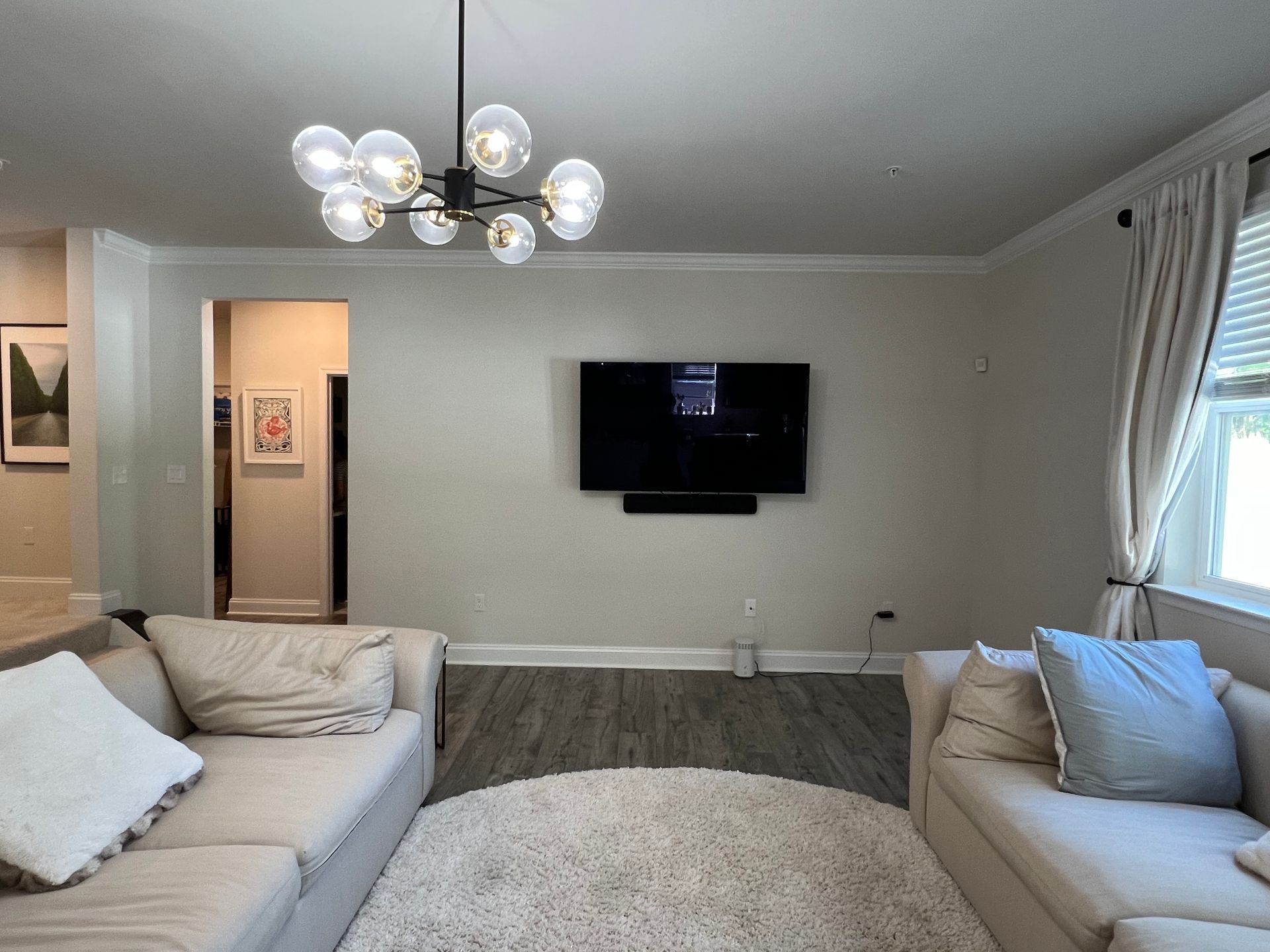 Modern black fireplace and media wall with blue lighting.