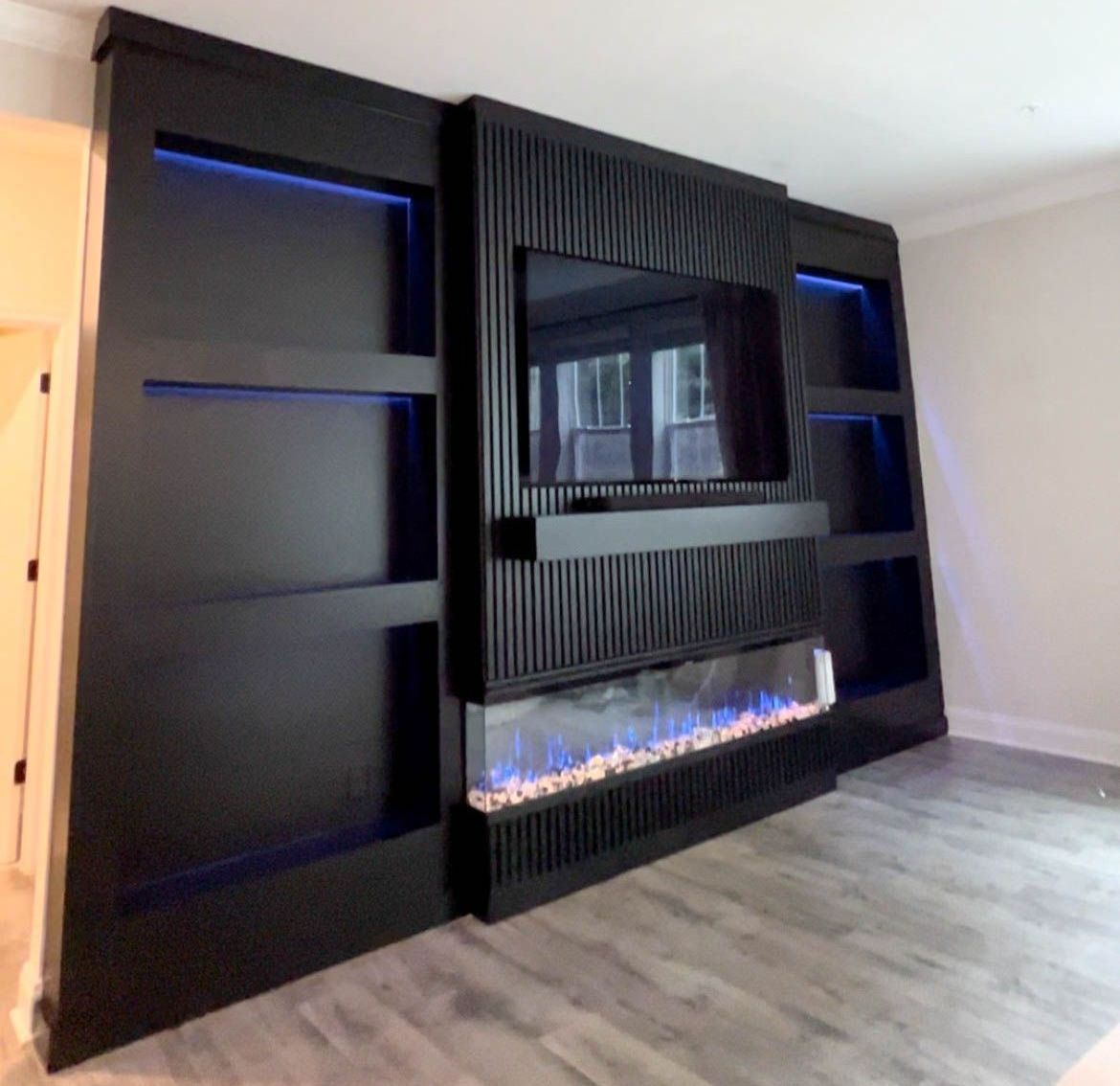 Dramatic living room upgrade in Bel Air! Custom fireplace & media wall creates a show-stopping focal point.