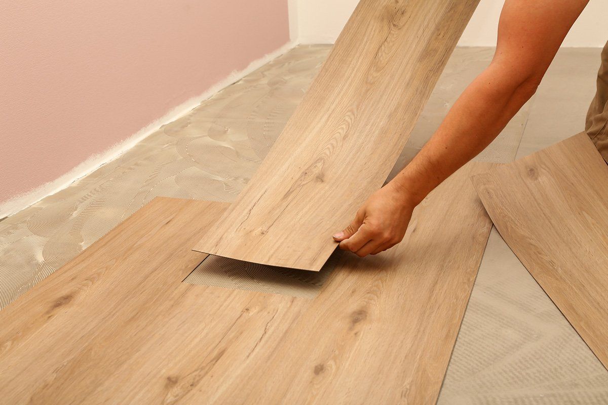 Worker Installing New Vinyl Tile Floor — Reisterstown, MD — A-1 Renovations