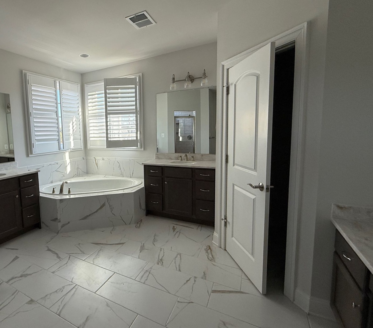 Before and after master bathroom remodel. We transformed an outdated space into a modern, bright design.