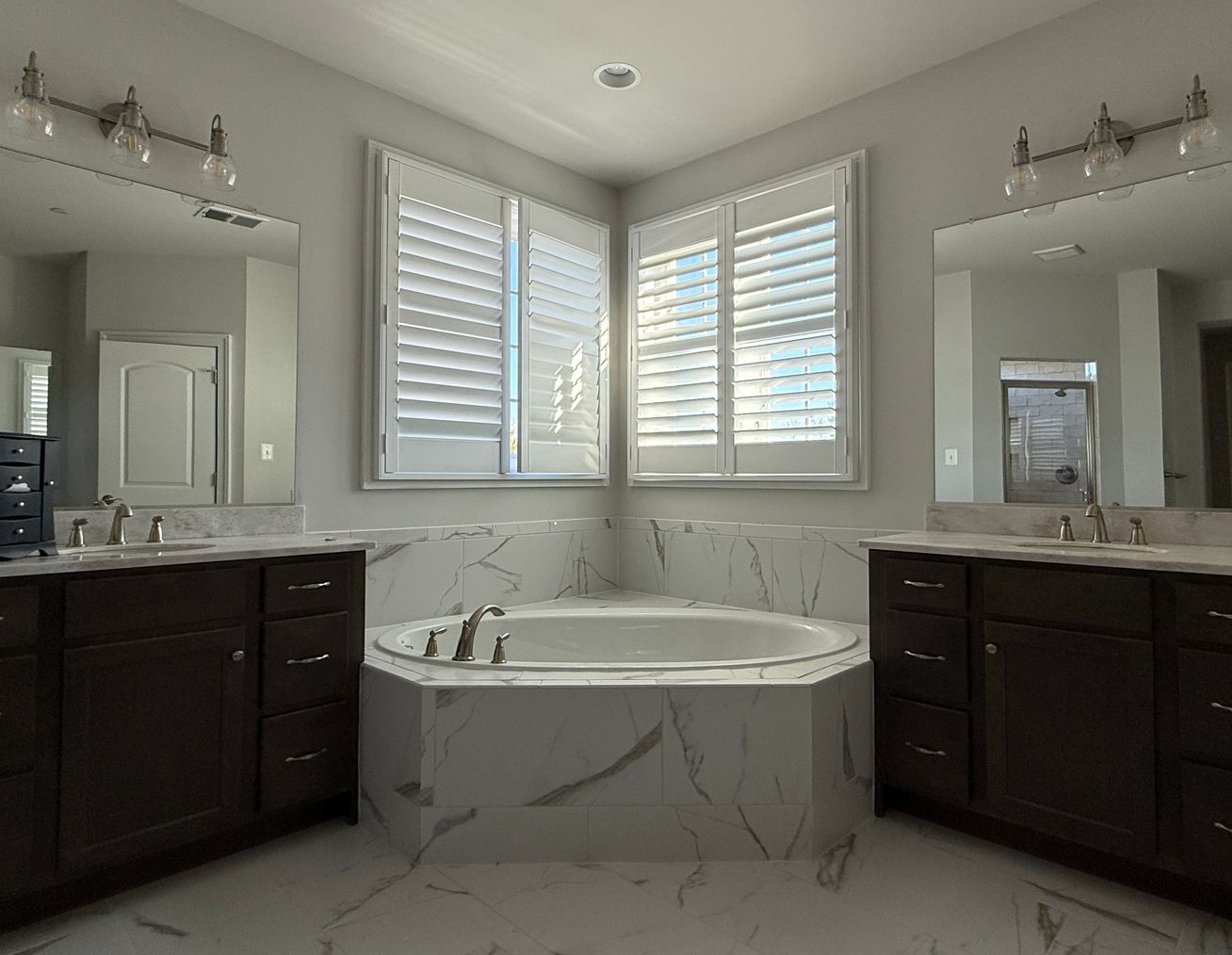Before and after: Our contractors completely updated this bathroom to include a heated floor and a frameless shower.