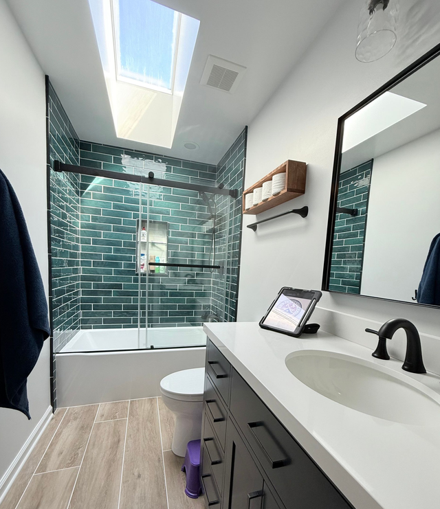 Ellicott City bathroom remodel featuring a teal subway tile shower and a dark vanity.