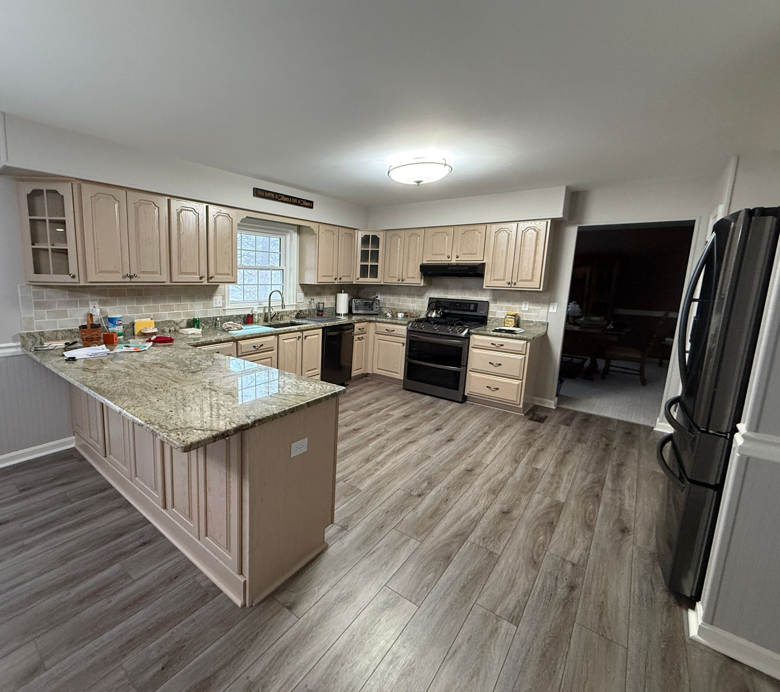 Original kitchen space featuring dark bulkheads, limited wall cabinetry, and older appliances.