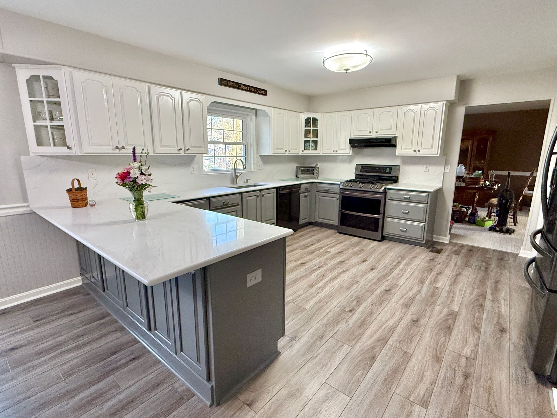 The completed project featuring a smooth, two-tone sprayed finish and seamless quartz countertops.