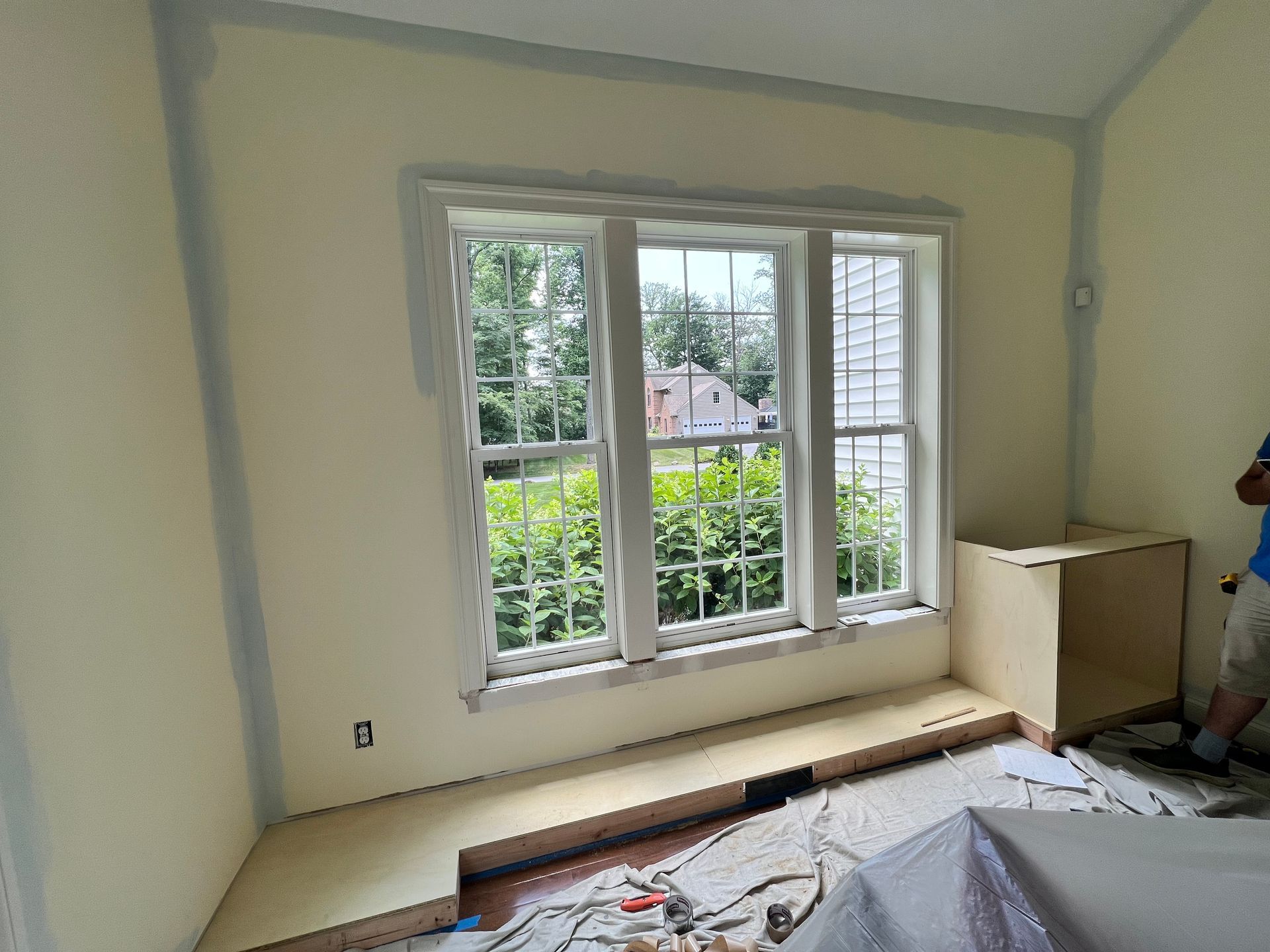 Built-in window seat with storage and flanking bookshelves, featuring a butcher block surface.