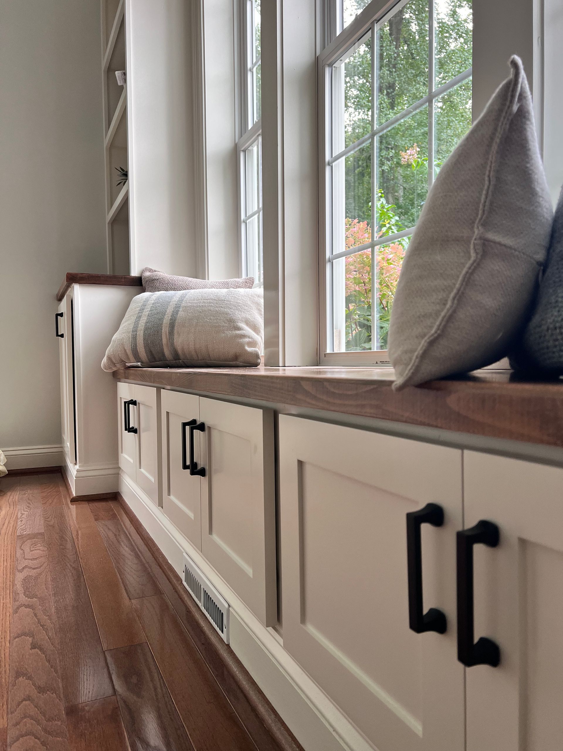 Custom window seat with bookshelves in Reisterstown, MD, featuring a butcher block countertop.