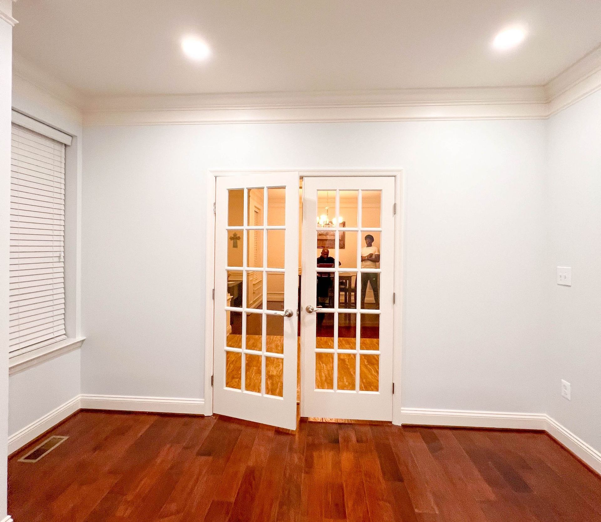 Stylish home office in Owings Mills with French doors and integrated columns.